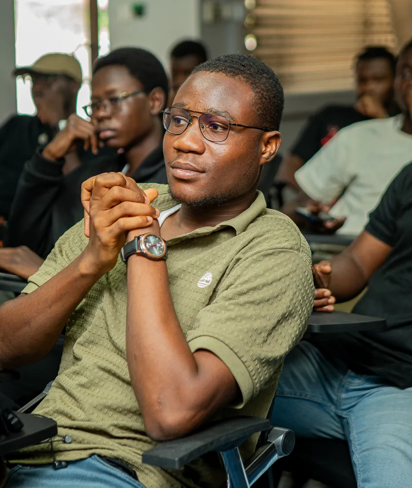 An attendee listening closely to a talk